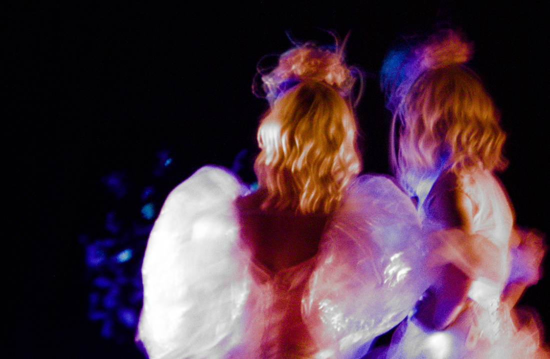 Two performers in translucent costumes
